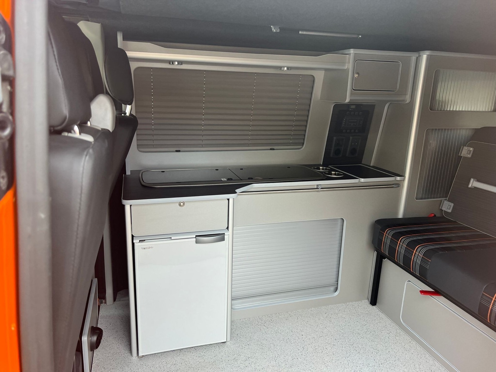 Fridge and work surface in a converted campervan